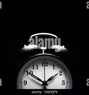 Alarm clock in the middle of the night isolated on black concept for insomnia or sleeplessn night Stock Photo