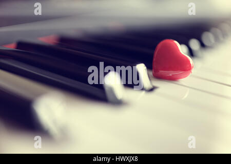 Red heart on piano keyboard keys concept for love of music or romance and valentines day Stock Photo