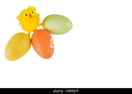 An easter chicken with three colored eggs on a white background and space for text. Stock Photo