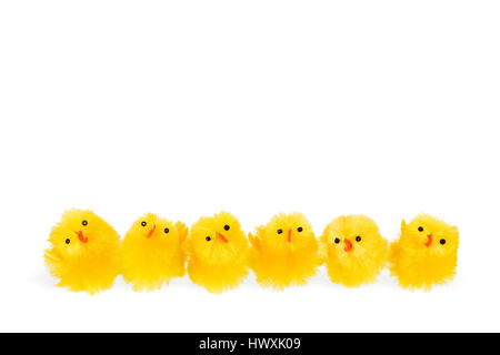 Six little yellow easter chickens on a row. The chickens are isolated on a white background and there is space for text. Stock Photo