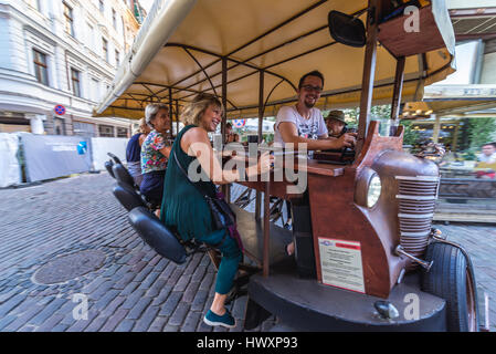 Party bike (also called cycle pub, beer bike or megacycle) on the Old Town of Riga, capital city of Republic of Latvia Stock Photo