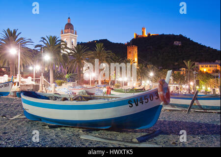 Boat on the cobblestones beach of Noli, facing the village of Noli, during the sunset Stock Photo
