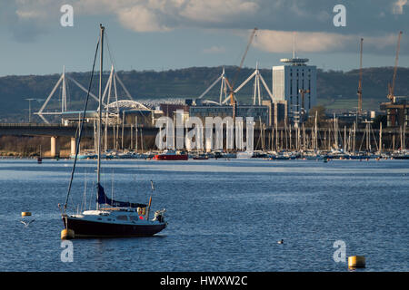 A general view over Cardiff Bay, Wales, UK, showing a boat in the foreground and the Principality Stadium (formerly the Millennium Stadium) in the bac Stock Photo