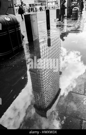 London black and white urban photography: Centre Point building reflected in puddle. London, UK Stock Photo