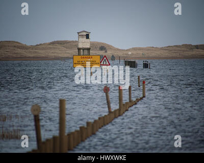 High tide on the causeway leading to the holy island of Lindisfarne, Northumberland Stock Photo
