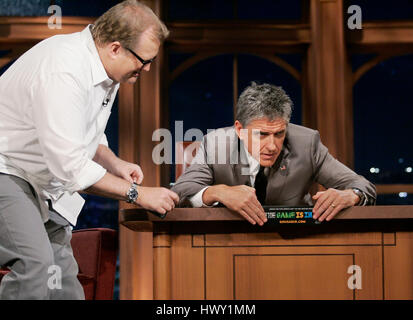 Drew Carey, left, and host Craig Ferguson put a sticker supporting the World Cup in the US during a segment of the 'Late Late Show with Craig  Ferguson' at CBS Television City in Los Angeles, California on September 10, 2009. Photo by Francis Specker Stock Photo