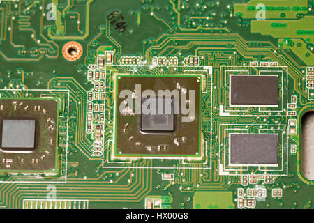 Close-up of electronic circuit board with chips and processors, motherboard laptop computer motherboard, CPU and graphics card scheme of electronic co Stock Photo