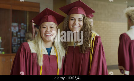 Portrait of smiling students posing at graduation Stock Photo