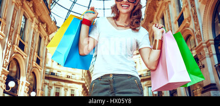 Discover most unexpected trends in Milan. Happy fashion woman with colorful shopping bags in Galleria Vittorio Emanuele II Stock Photo