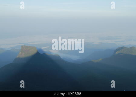 Adam's Peak casting its sunrise shadow on the Central Highlands of Sri Lanka Stock Photo