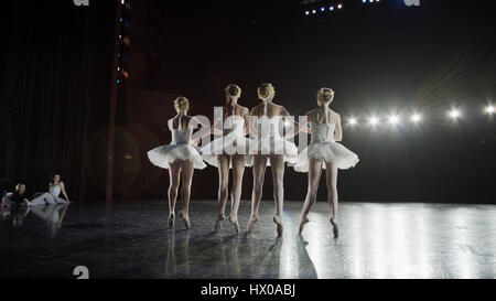 Low angle view of serious ballet dancers in costume performing onstage in show Stock Photo