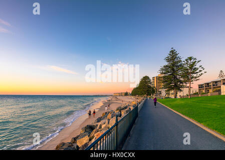 Adelaide, Australia - February 11, 2016: People walking along Esplanade at  Glenelg Beach. Esplanade is a very popular place among locals and tourists Stock Photo