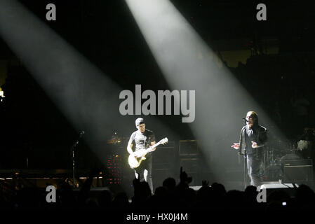 Lead singer of U2, Bono, with The Edge,  in concert in San Diego, CA on March 28 2005 Photo credit: Francis Specker Stock Photo