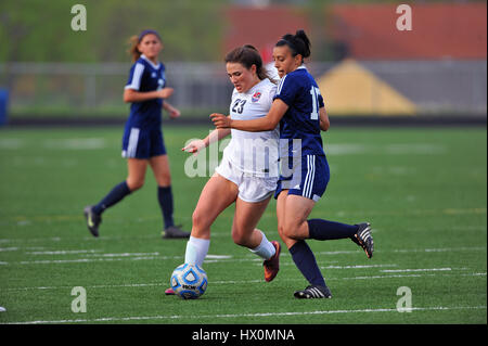 Opposing players battling for control of the ball.during a high school soccer match. USA. Stock Photo