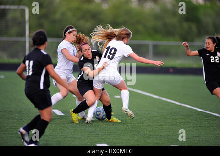 Opposing players battling for control of the ball. Stock Photo