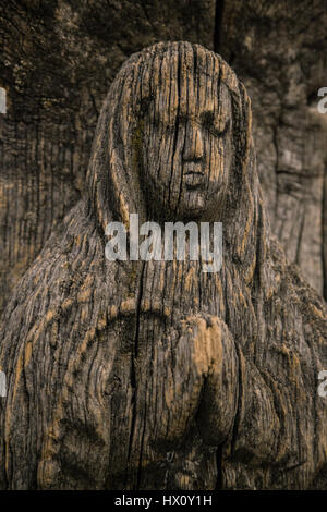 Virgin Mary carved on ancient wooden icon Stock Photo