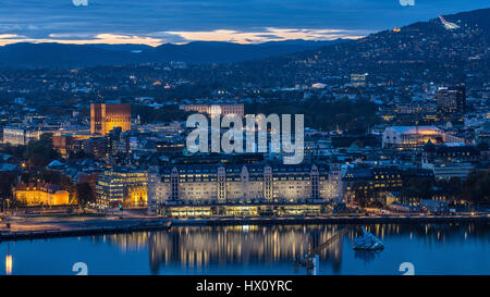 Overlooking Norway’s capital Oslo at night includes tourist attractions and landmarks such as Oslo Rådhus (Oslo City Hall), the ski jump Holmenkollen  Stock Photo