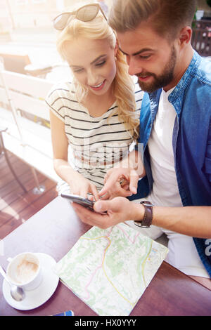 Couple using smartphone in the cafe Stock Photo