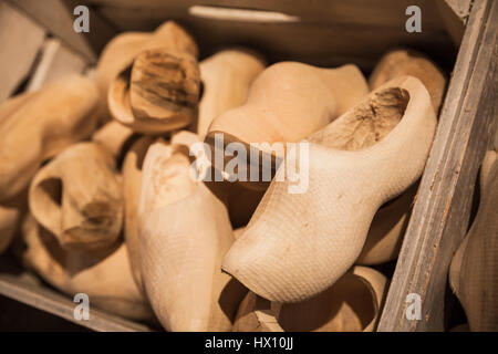 Defected clogs made of poplar wood. Klompen, traditional Dutch shoes for everyday use lay in wooden boxes Stock Photo