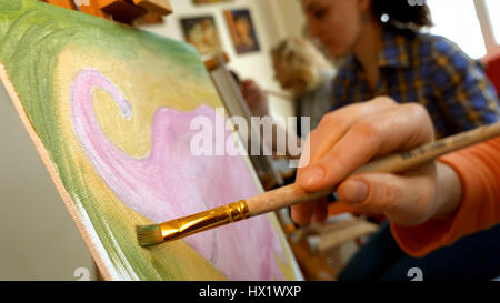 Female artist draws a pencil sketch in art studio Stock Photo