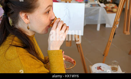 Graphic artist having a snack break drinking tea Stock Photo