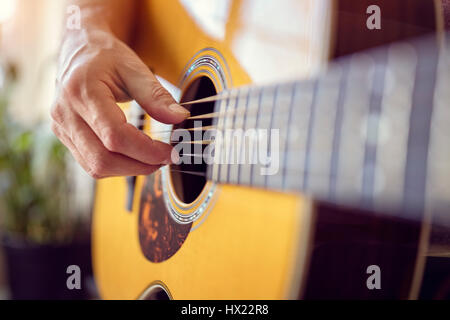 Man playing an acoustic guitar Stock Photo