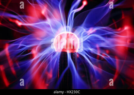 Plasma ball lamp energy, touching glowing glass sphere concept for power, electricity, science and physics Stock Photo