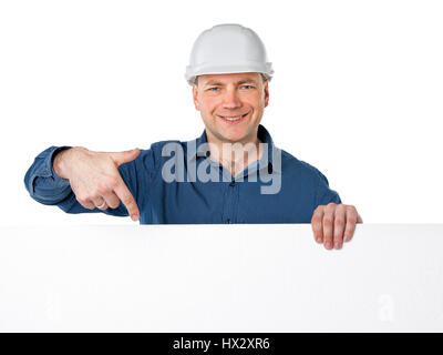 a man in a construction helmet holding a white plastic foam and points a finger at him Stock Photo