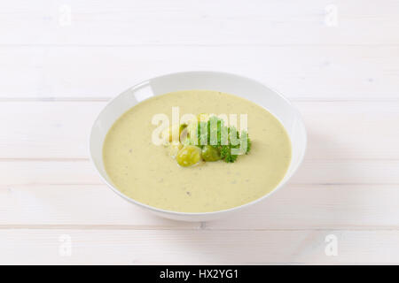 plate of vegetable soup with Brussels sprouts on white background Stock Photo