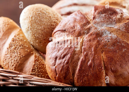 Assortment of baked bread in wicker basket Stock Photo