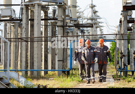 Working with a tool in the hands against the background of power plant Stock Photo