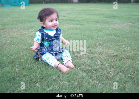 cute indian baby asking playing at local garden somewhere at india Stock Photo