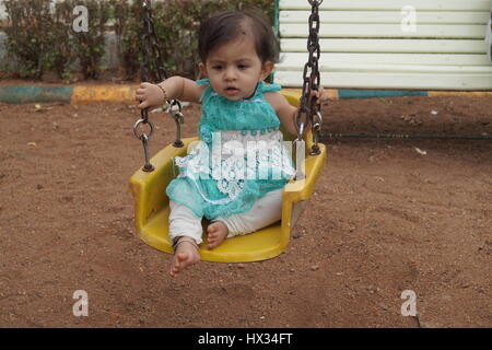 cute indian baby asking playing at local garden somewhere at india Stock Photo