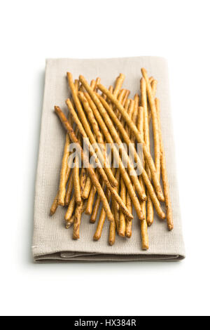 Salty pretzel sticks on napkin isolated on white background. Stock Photo