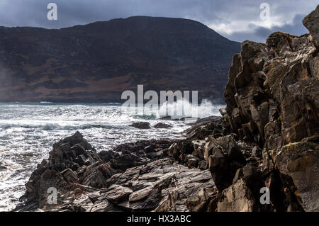 Waves break on Maghera beach rocks near Ardara, County Donegal, Ireland part of Ireland's Wild Atlantic Way Stock Photo