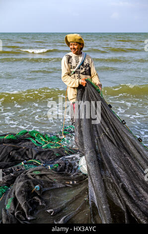 A Filipino fisherman uses his seine net on Baybay Beach, Roxas City, Capiz, Panay Island, Philippines. Stock Photo