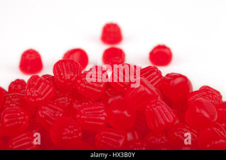 Pile of raspberry jelly candies isolated on white background. Stock Photo