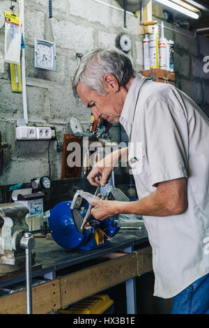 Close-up of workman working with iron Stock Photo