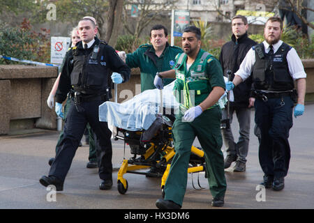London UK 22 March 2017 A member of the public is brought into St Thomas hospital by Paramedics and police. A police officer has been stabbed near to 