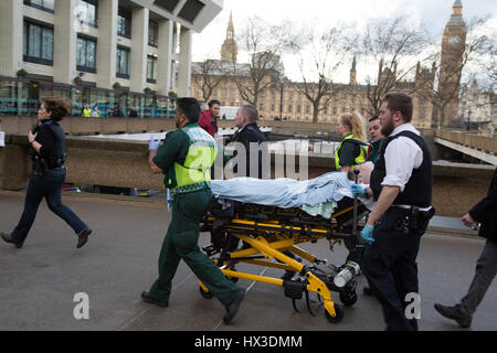 London UK 22 March 2017 A member of the public is brought into St Thomas hospital by Paramedics and police. A police officer has been stabbed near to 