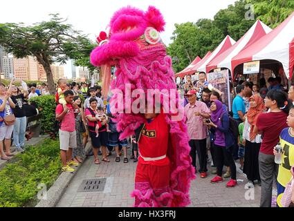 KAOHSIUNG, TAIWAN -- JUNE 20, 2015: Two young men perform a traditional lion dance during the 2015 Dragon Boat Festival activities. Stock Photo