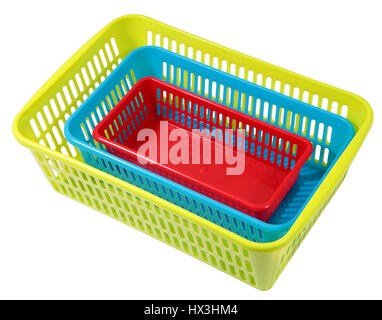 Nested in one another, different size and different colored, perforated plastic boxes, storage systems for domestic use, isolated on white. Stock Photo