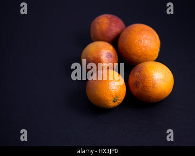Blood oranges isolated on dark background Stock Photo