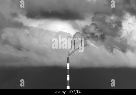 Industrial power station and smoke generate pollution and global warming over the world in monochrome black and white image Stock Photo