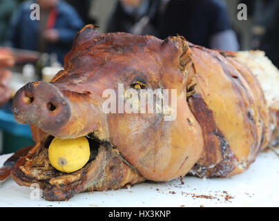 Muzzle for roast pork with Yellow Lemon in Mouth Stock Photo