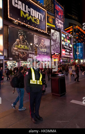 New York, USA - November 20, 2011: NYPD Policeman on duty at night Times Square, Manhattan, New York, USA. Stock Photo