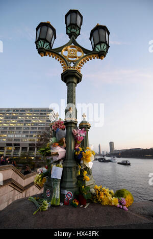 London, UK.  24 March 2017.  Every lamp post on Westminster Bridge carries floral tributes following the terrorist attack in Westminster where five lost their lives and 40 people were injured. Credit: Stephen Chung / Alamy Live News Stock Photo