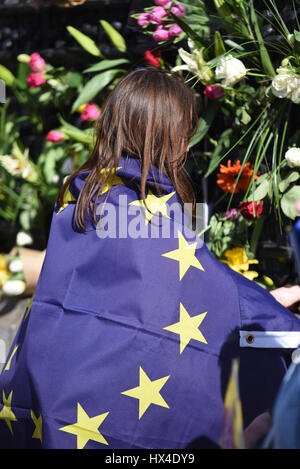 Many of the Unite protestors added flowers to the fence at the Palace of Westminster after marching from Park Lane demonstrating against 'Brexit'. They were placed to honour the lives lost during Wednesday's terrorist attack Stock Photo