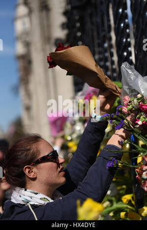 Many of the Unite protestors added flowers to the fence at the Palace of Westminster after marching from Park Lane demonstrating against 'Brexit'. They were placed to honour the lives lost during Wednesday's terrorist attack Stock Photo