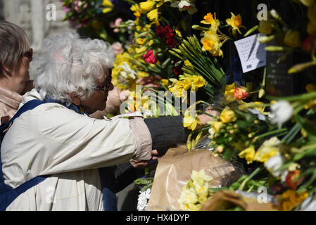 Many of the Unite protestors added flowers to the fence at the Palace of Westminster after marching from Park Lane demonstrating against 'Brexit'. They were placed to honour the lives lost during Wednesday's terrorist attack Stock Photo